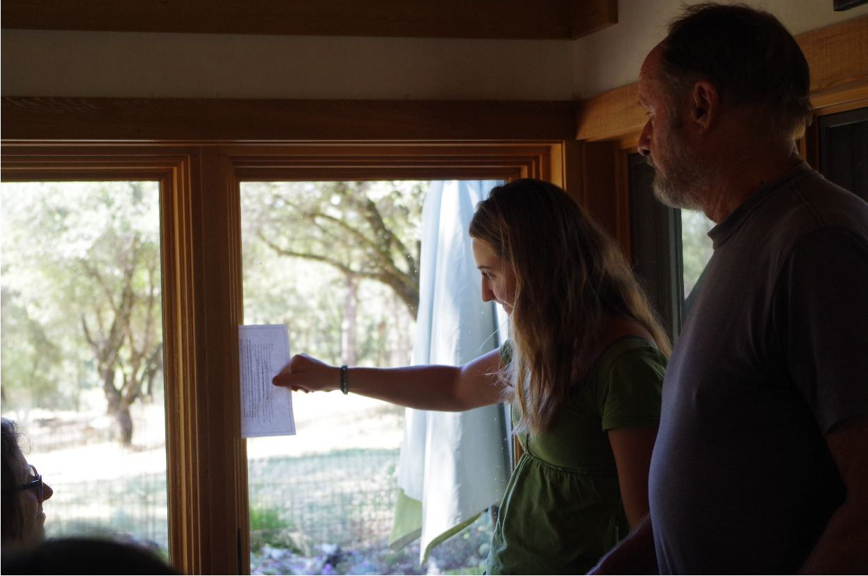 Eric Jorgensen offered a low-tech method to check for energy-efficient windows, as Jessica Rivenes conducted the demonstration. (Photo by Amelia Regan)